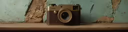 an old camera is sitting on a ledge