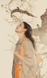 a woman is standing underneath the branches of a tree