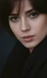 a woman with dark hair and big blue eyes