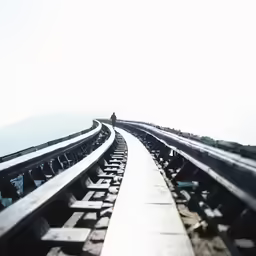 the side of a large train track with two trains