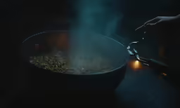 someone frying pistachios in an enormous pan with smoke