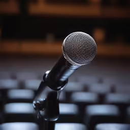 an old microphone placed in front of a row of chairs