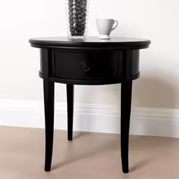 a black table with flowers in vase on top