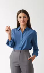 a young girl with brown hair and blue shirt holding her hand up