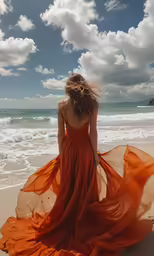 the girl in a long dress walks along the beach