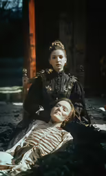 a woman and her mother sitting on the ground