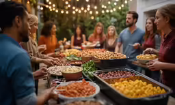 a buffet line with people standing around and eating