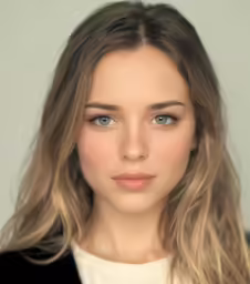 a women with long hair and blue eyes staring directly at the camera