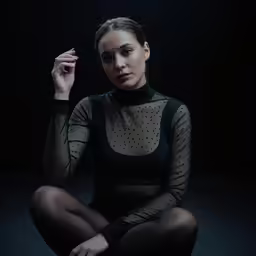 the woman in black is sitting on the floor