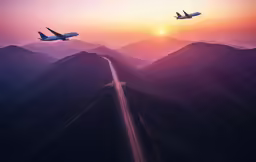 the jet airliner is flying over a mountain pass