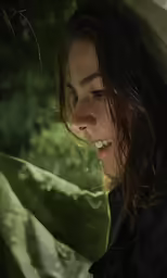 a woman with a wet hair is holding an umbrella