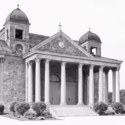 the front entrance of the old building with two towers