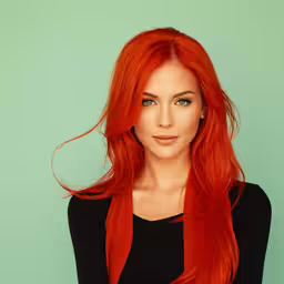 an attractive woman with long red hair posing