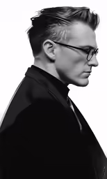 the man has black hair and is wearing glasses