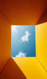 a view from inside a rectangular window, with clouds above