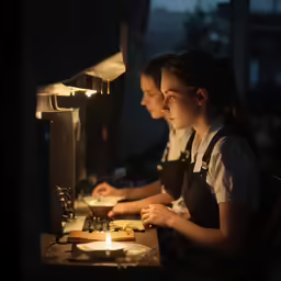a group of young people are working at a table