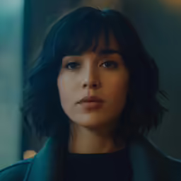 a woman looking into the distance with a serious look