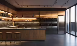 a large kitchen with two stools that are underneath lights