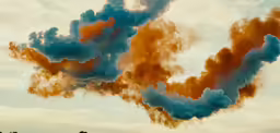 smoke billowing out of the top of a building