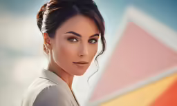 a woman with a messy bun and light makeup