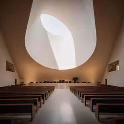 a long empty church with no people inside