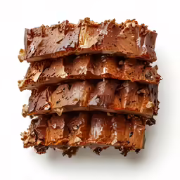 several slices of brownie are covered in chocolate and nutella