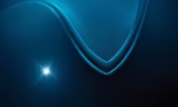 a blue abstract wallpaper with bright light shining in it