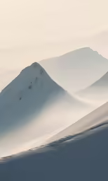 many large snow covered hills with trees on them