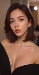 a young woman in black dress posing for a picture