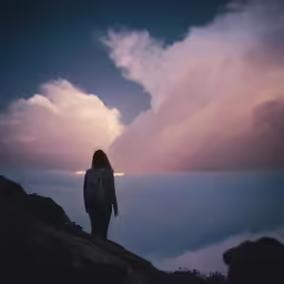person looking at a view on top of mountain