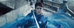 an attractive young lady holding a white and black sword