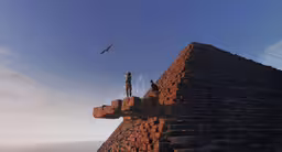 two people are standing on top of a tall stone structure,a man standing on a stone pillar by the ocean