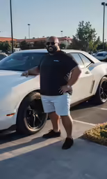 a man standing next to a white car with one leg on it