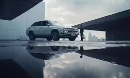 the white car is reflected in the reflective water