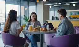 a man and two women eating at an outdoor cafe