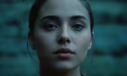 a young woman is frowning while posing for the camera