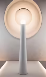 the tall white light is in a dark room