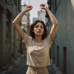 a woman with long hair wearing a beige top is standing on an alley way