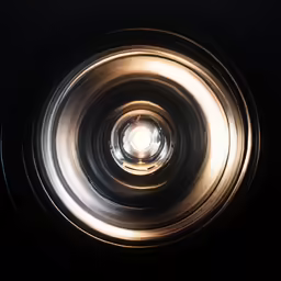 a gold and black bowl on a black surface