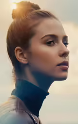 the woman with a hair bun in her bun looks back to the side
