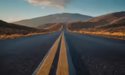 the empty road has a yellow line in the middle