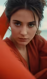 a woman in red top looking at camera