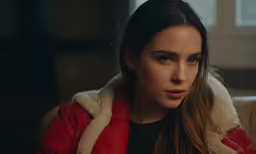 a close up of a person wearing a red jacket