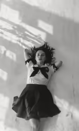 a young woman is wearing an over sized skirt with a bow on her head