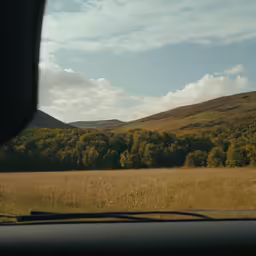 the photo is taken from inside the car while it is driving down the road