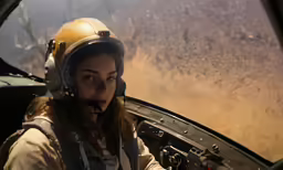 a young lady with a helmet in an airplane