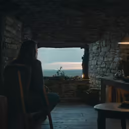 a woman in a chair is sitting in front of the window