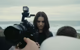the woman is being video wrapped in by a professional photographer