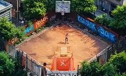 an aerial view of a bull ring with a boy playing