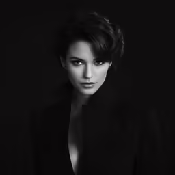 a woman in black jacket posing for a picture